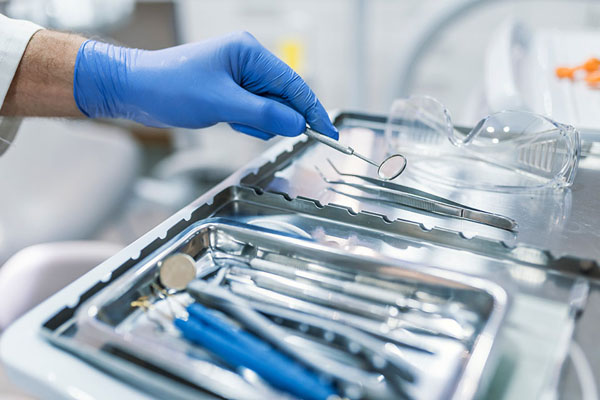 dentist using a variety of dental tools during treatment