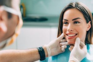 dentist looking at a patient's smile