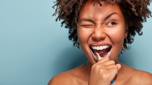 Young woman brushing her teeth