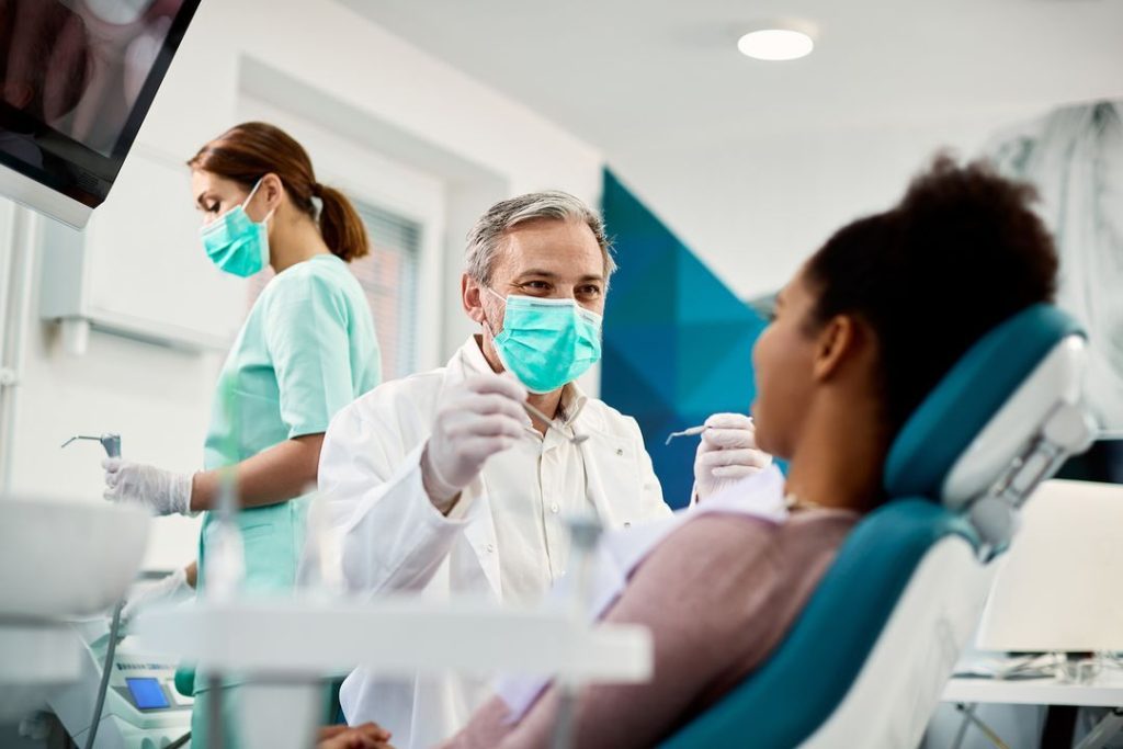 dentist performing a dental cleaning for a patient