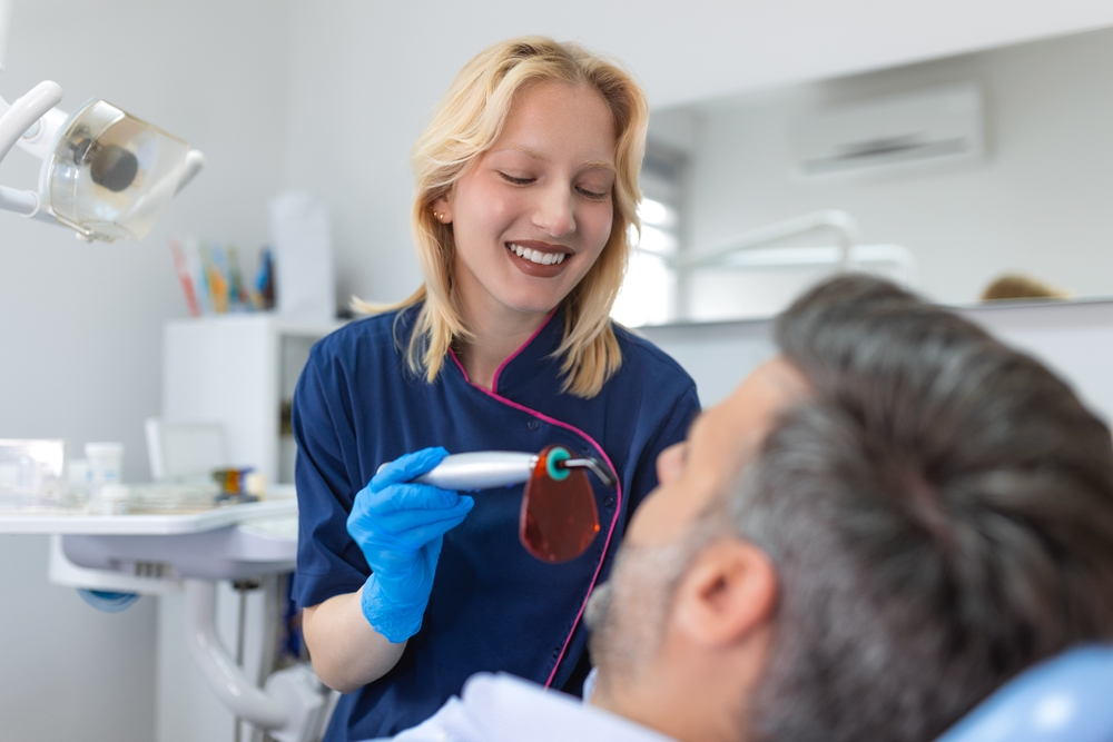 close up of a man undergoing laser tooth whitening